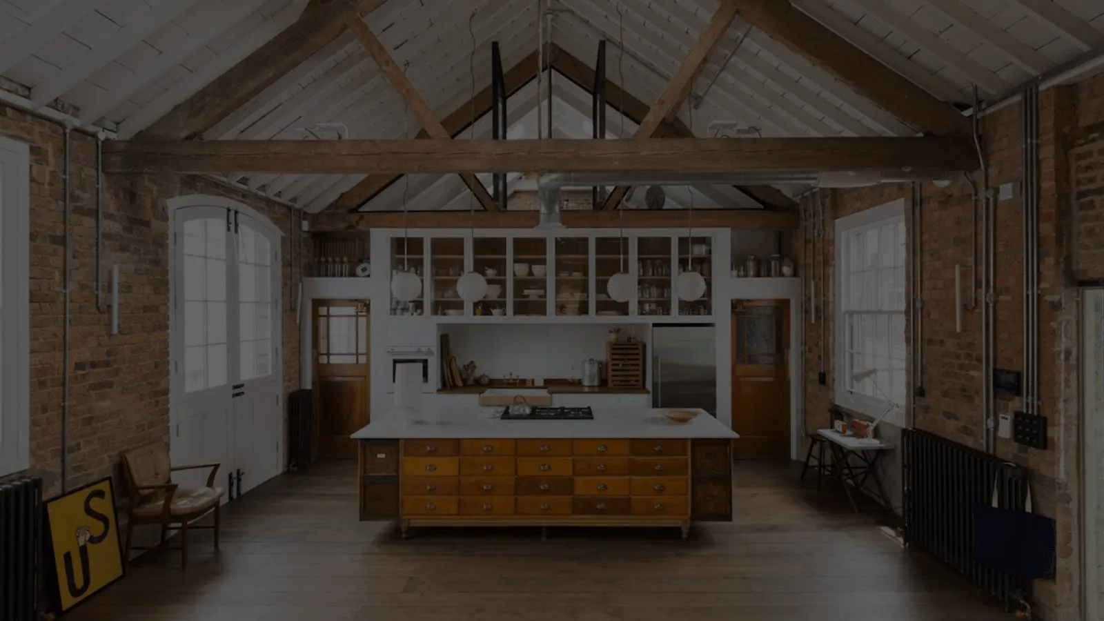 Restored mill loft with exposed brick and timber trusses