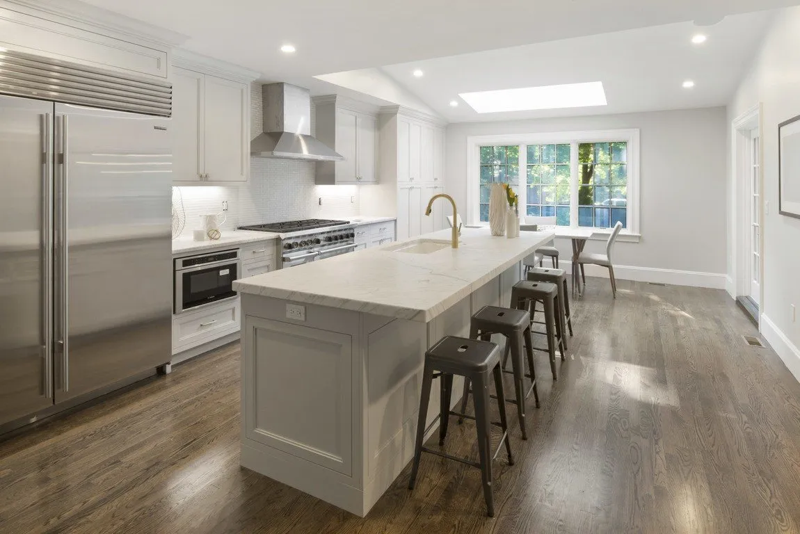 Renovated white kitchen with marble island